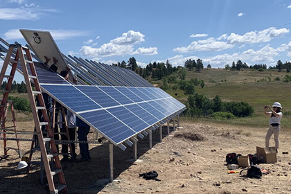 Photo of a workers installing a solar power array