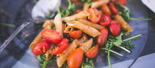 pasta dish with tomatoes and kale