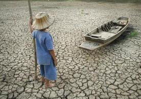 child looking at boat on dry land